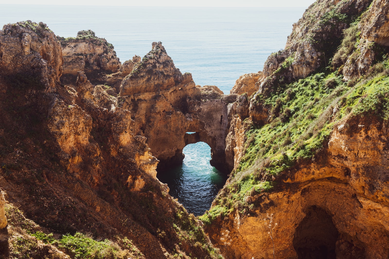 brown rock formation near body of water during daytime