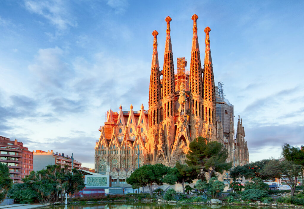 Barcelona, Spain - February 10th, 2016: Tourists at backside of famous church and cathedral Sagrada Familia in Barcelona. Seen from subway station Sagrada Familia. Church also called Temple Expiatori de la Sagrada Família - famous basilica built by Antoni Gaudi in year 1882 and til today not finished. Church is located in district Eixample in North of town. Some parts of church are UNESCO World Heritage.