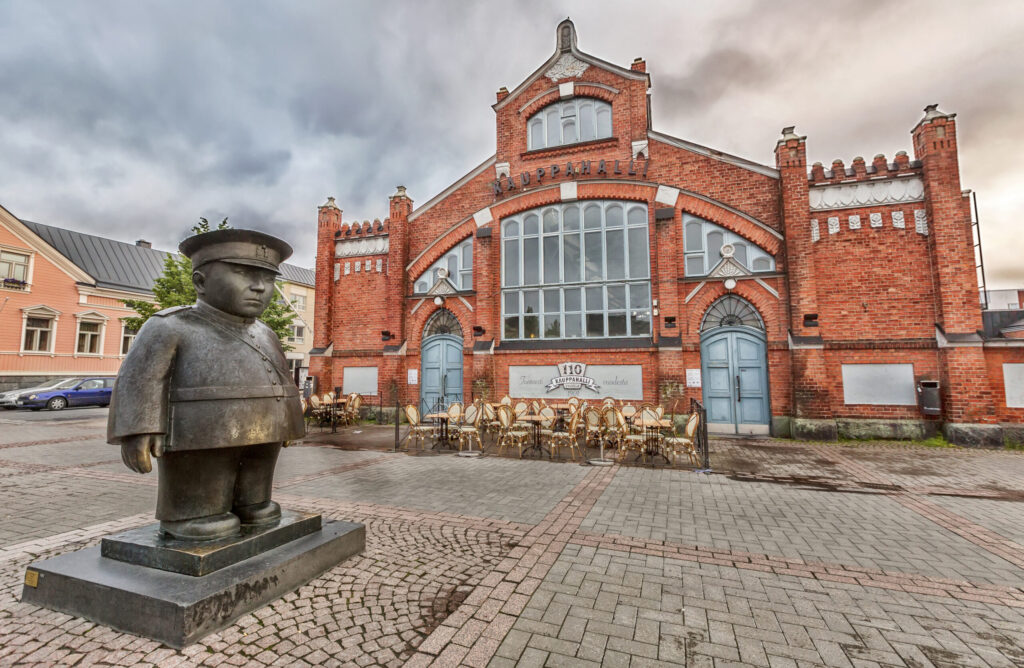 Oulu, Finland - July 6, 2016: Market Square, located in front of the Market Hall with Policeman statue (Toripolliisi) by Kaarlo Mikkonen.