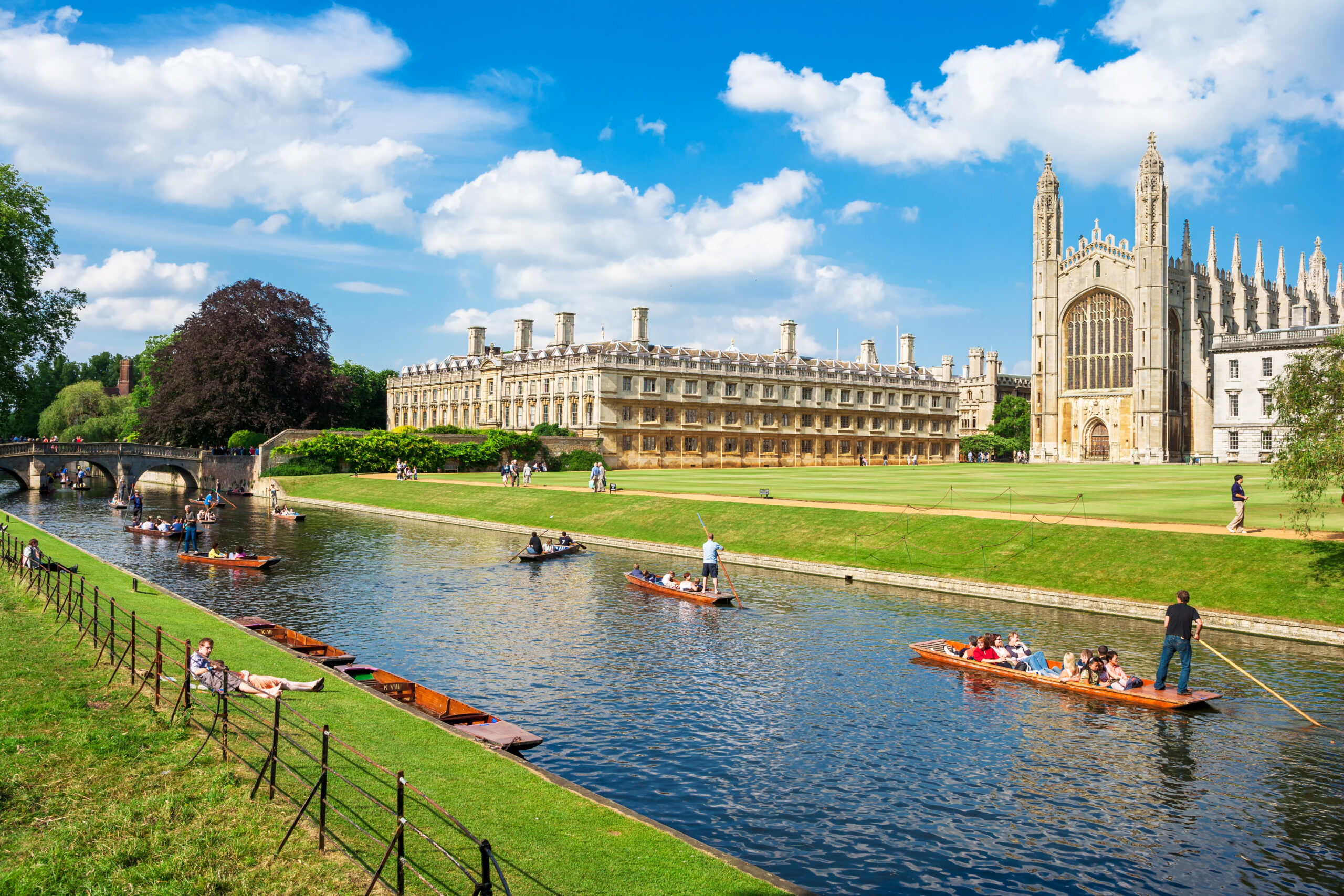 Cambridge, Cambridgeshire, England - June 24, 2006: Tourists on punt trip (sightseeing with boat) along River Cam near Kings College in the city of Cambridge, England