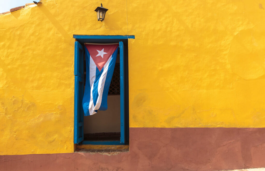 Cuban flag hanging on a door in Trinidad, Cuba
