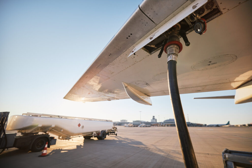 Refueling of airplane at airport. Ground service before flight.