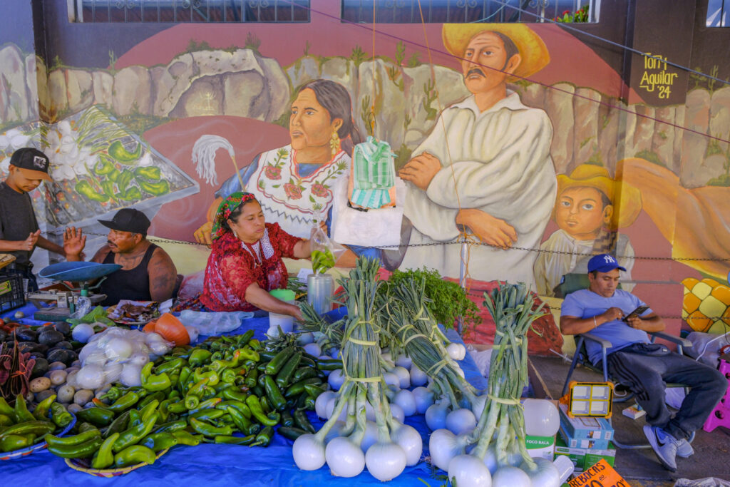 Tlacolula de Matamoros, Mexico - March 2, 2025: Vegetable vendors at the Sunday Market in Tlacolula de Matamoros, Oaxaca, Mexico.