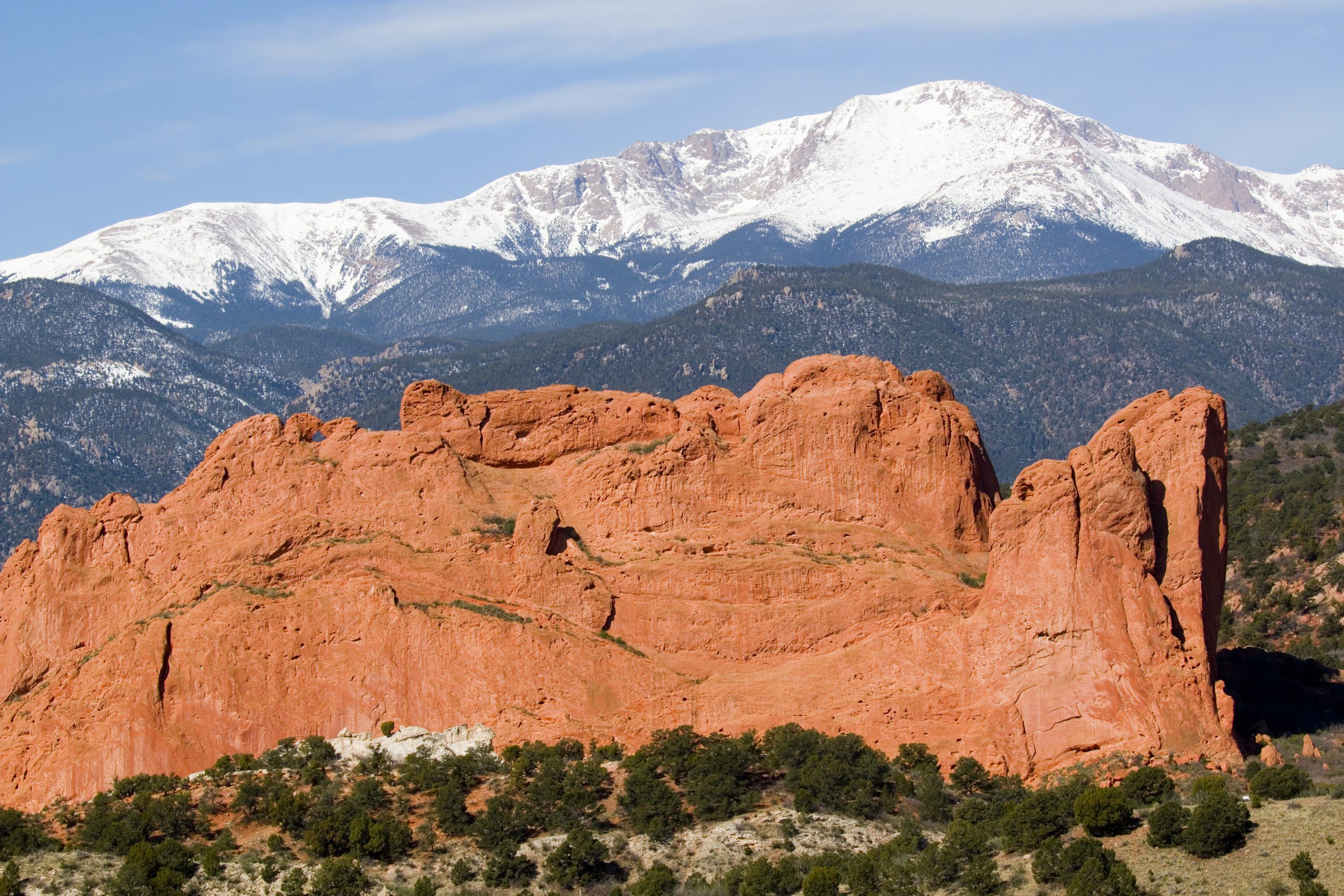 Snow-covered Pikes Peak behind the red sandstone formations of Garden of the Gods in Colorado Springs