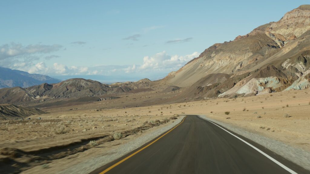 Road through the arid landscape of Artists Palette Drive in Death Valley