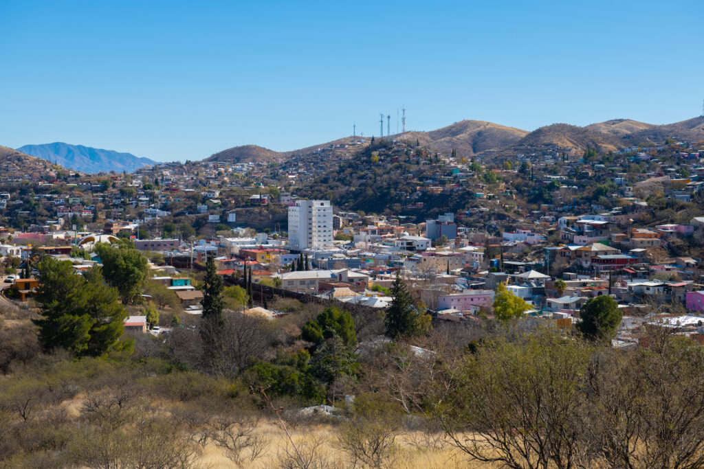 Buildings of Nogales, Sonora, spread across dry hills under a blue sky
